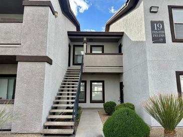 Condo exterior with stairs leading to unit, desert landscaping, and building number at 45 Maleena Mesa St # 1921, Henderson, NV 89074