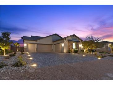 Charming home featuring a spacious driveway and a well-manicured yard at dusk at 7277 W Landberg Ave, Las Vegas, NV 89178
