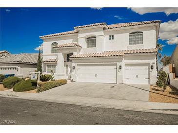 Beautiful two-story home with a three-car garage and manicured front yard landscaping at 7464 Forestdale Ct, Las Vegas, NV 89120