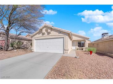 Charming single-story home with a two-car garage and low maintenance desert landscaping at 8468 W Gilmore Ave, Las Vegas, NV 89129