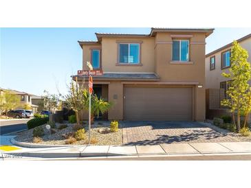 Charming two-story home with a brick driveway, well-maintained landscaping, and a two-car garage at 12381 Liberty Beacon Ave, Las Vegas, NV 89138