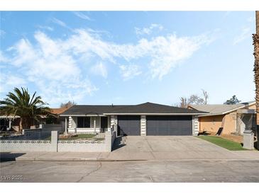 Charming single-story home featuring a two-car garage, modern paint scheme, and well-maintained front yard at 2549 Pine Creek Rd, Las Vegas, NV 89115