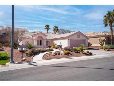 Charming single-story home with desert landscaping, palm trees, and a two-car garage at 3025 Treesdale Dr, Las Vegas, NV 89134