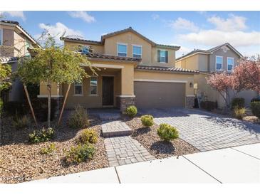 Inviting two-story home featuring a meticulously landscaped front yard and a convenient two-car garage at 3167 Biccari Ave, Henderson, NV 89044