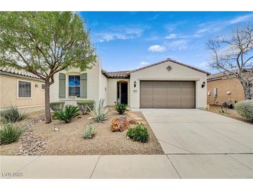 Charming home with a two-car garage, desert landscaping and a well-maintained front yard at 3717 Rocklin Peak Ave, North Las Vegas, NV 89081