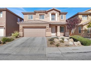 Charming two-story home with a landscaped front yard and a two car garage at 4036 W Bird Man Ln, North Las Vegas, NV 89084