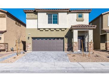 Charming two-story home with a two-car garage and a well-manicured front yard at 480 Silverweed Ave, Henderson, NV 89044