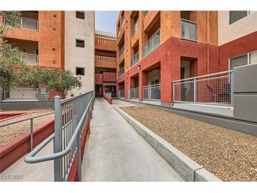 Exterior view of multi-story building featuring a ramp for accessibility and colorful facades at 51 E Agate Ave # 506, Las Vegas, NV 89123