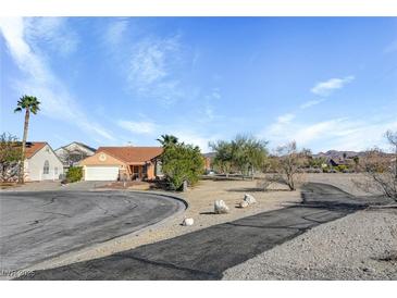 Single story home with a terra cotta roof, desert landscaping and an attached two car garage at 540 Viva Serenade Way, Henderson, NV 89015