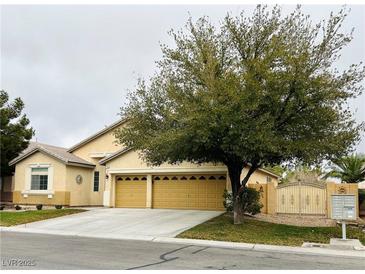 Traditional single-story home with three-car garage and mature landscaping enhancing curb appeal at 7172 Painted Paradise St, Las Vegas, NV 89131
