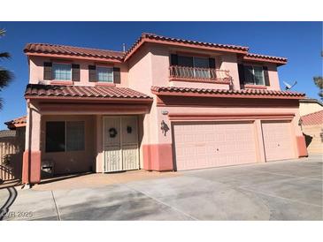 Charming two-story home with a three-car garage and balcony detail, showcasing a delightful exterior at 8122 Delphi Ct, Las Vegas, NV 89117