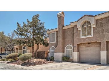 Inviting home exterior with a private garage and mature landscaping at 10115 Tree Bark St, Las Vegas, NV 89183