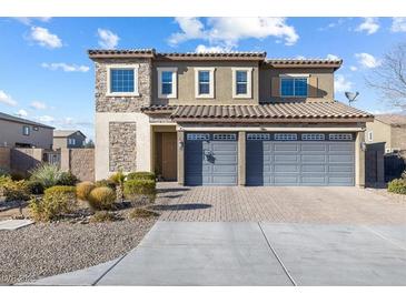 Two-story home showcasing stone accents and a three-car garage, complemented by neat landscaping at 3386 W Haleh Ave, Las Vegas, NV 89141