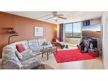 Cozy living room with large window and comfortable seating arrangement and city views at 3930 University Center Dr # 804, Las Vegas, NV 89119
