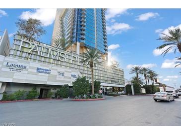 View of the Palms Place building with hotel and tanning businesses and parked cars on a bright, sunny day at 4381 W Flamingo Rd # 922, Las Vegas, NV 89103