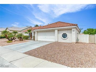Charming single-story home with a tile roof, desert landscaping, and a two-car garage at 7820 Wedlock Ln, Las Vegas, NV 89129