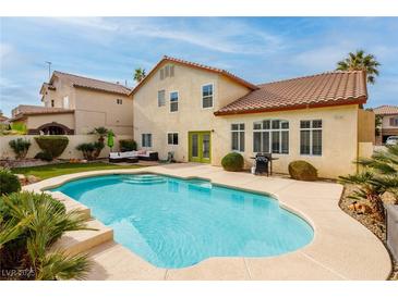 Inviting backyard pool with lush landscaping, perfect for outdoor entertaining and relaxation at 9446 Bondeno St, Las Vegas, NV 89123