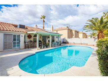 Sparkling pool with covered patio provides an oasis for relaxation and entertaining at 9564 Summer Cypress St, Las Vegas, NV 89123