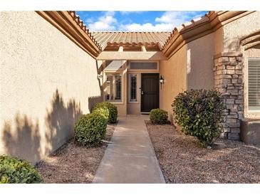 Inviting front entrance with desert landscaping and a sheltered walkway to the front door at 10408 Georgetown Pl, Las Vegas, NV 89134