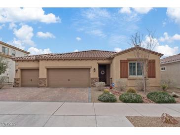 Charming single-story home featuring a three-car garage, desert landscaping and a tile roof at 1269 Olivia Pkwy, Henderson, NV 89011