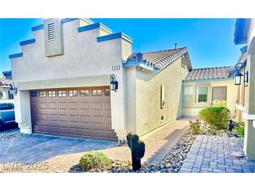 Charming single-story home featuring desert landscaping, a two-car garage, and a tile roof at 2175 Limestone Cove Ct, Laughlin, NV 89029