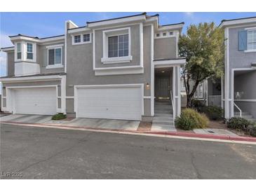 Contemporary townhome with gray stucco and white trim, plus a two-car garage at 2572 Favorable Pointe Ct, Henderson, NV 89052
