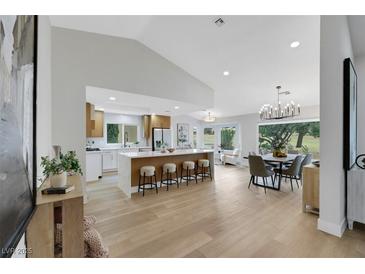 Open-concept kitchen with breakfast bar, stainless appliances, and adjacent dining area offering seamless entertaining at 2817 Billy Casper Dr, Las Vegas, NV 89134