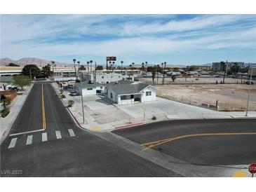 Charming single-story home on a corner lot with ample parking and palm tree lined street at 330 N 9Th St, Las Vegas, NV 89101