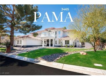 Stunning two-story home with a beautifully landscaped front yard and circular driveway at 3465 Pama Ln, Las Vegas, NV 89120