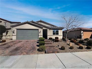 Charming single-story home featuring a low-maintenance front yard and a two-car garage at 3726 Shaving Shadows Ave, North Las Vegas, NV 89032