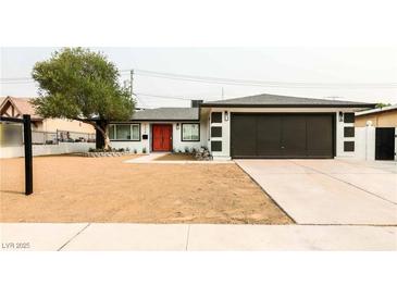 Charming single story home with a freshly landscaped front yard, long driveway, and stylish black and white exterior at 4308 San Bernardino Ave, Las Vegas, NV 89102