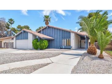 Charming single-story home boasts desert landscaping, a paved walkway, and a convenient attached two-car garage at 5120 Burnham Ave, Las Vegas, NV 89119