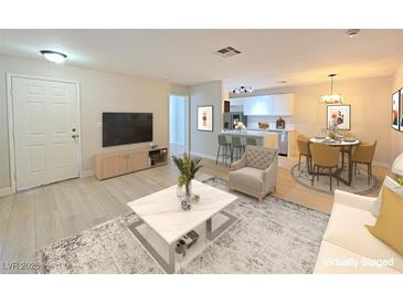 Bright living room showcasing an open floorplan, modern furnishings, and hardwood-style floors at 5161 Lindell Rd # 104, Las Vegas, NV 89118
