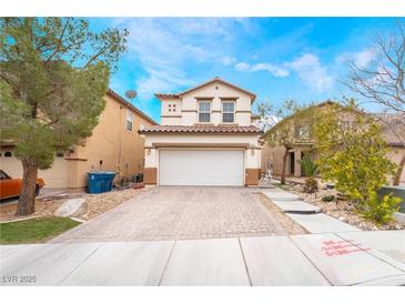 Charming two-story home featuring a paved driveway and a well-maintained front yard at 6177 W Cougar Ave, Las Vegas, NV 89139