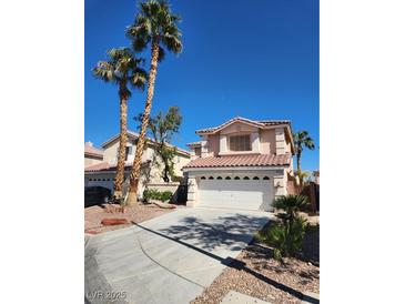 Charming two-story home featuring a tile roof, mature palm trees, and a two-car garage at 7416 Tuckaway Harbor St, Las Vegas, NV 89139