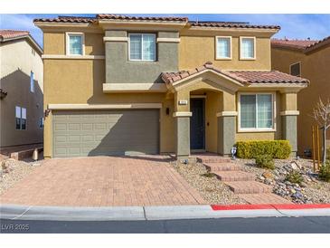 Inviting two-story home features a charming front yard, two car garage and a red tile roof at 806 Neath Ave, Las Vegas, NV 89178