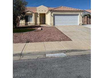 Charming single-story home with a two-car garage and low-maintenance desert landscaping at 807 Airy Hill St, Henderson, NV 89015