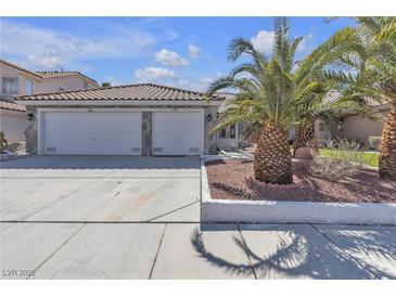 Charming single-Gathering home with a two-car garage, and desert landscaping with palm trees at 897 Cavaison Ave, Las Vegas, NV 89123