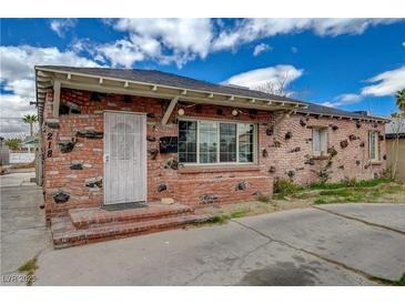 Unique brick home exterior with decorative stones and a secure metal gate at 218 S Bruce St, Las Vegas, NV 89101