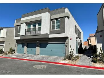 Modern townhome showcases a private balcony above a teal two-car garage with well-maintained landscaping at 4924 Chidlaw Ave # 3, Las Vegas, NV 89115