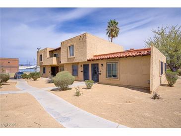 Inviting two-story building featuring a desert landscape with a palm tree in view at 5706 W Lake Mead Blvd, Las Vegas, NV 89108