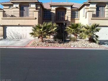 Spacious townhome featuring a two-car garage and desert landscaping at 9301 Harrow Rock St, Las Vegas, NV 89143
