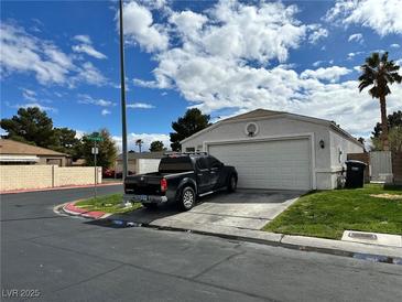 Charming single-story home with a well-maintained front yard and a two-car garage at , Las Vegas, NV 89106