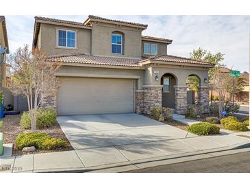 Charming two-story home featuring a tile roof, neutral stucco, stone accents, and a two-car garage at 1053 Hickory Park St, Las Vegas, NV 89138
