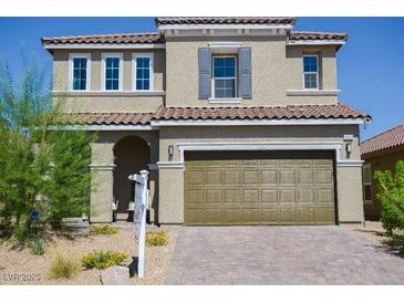 Two-story home with a two-car garage, desert landscaping, and a neutral-toned facade at 1122 Brilliant Meadow Ave, North Las Vegas, NV 89086