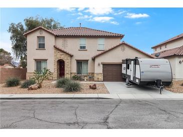 Inviting two-story home featuring stone accents, a two-car garage, and a charming, low-maintenance front yard at 1495 Le Luberon Ct, Las Vegas, NV 89123