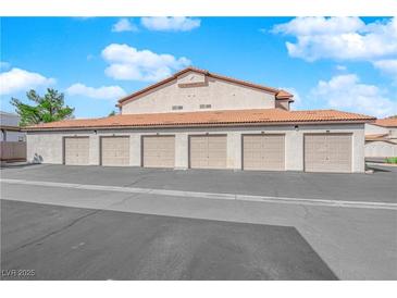 Multiple car garages with individual doors for resident parking with red tile roofs at 2615 W Gary Ave # 1028, Las Vegas, NV 89123