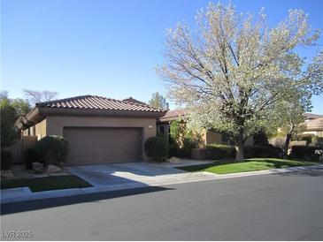Charming single-story home featuring a well-manicured front yard and a two-car garage at 32 Feather Sound Dr, Henderson, NV 89052