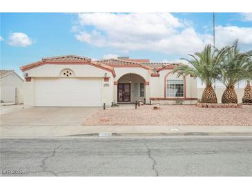 Charming single-story home featuring a landscaped front yard and a two-car garage at 430 Nancy Dr, Henderson, NV 89015