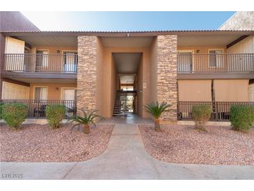 Charming condo complex featuring stone accents and well-maintained landscaping at 4941 River Glen Dr # 4, Las Vegas, NV 89103